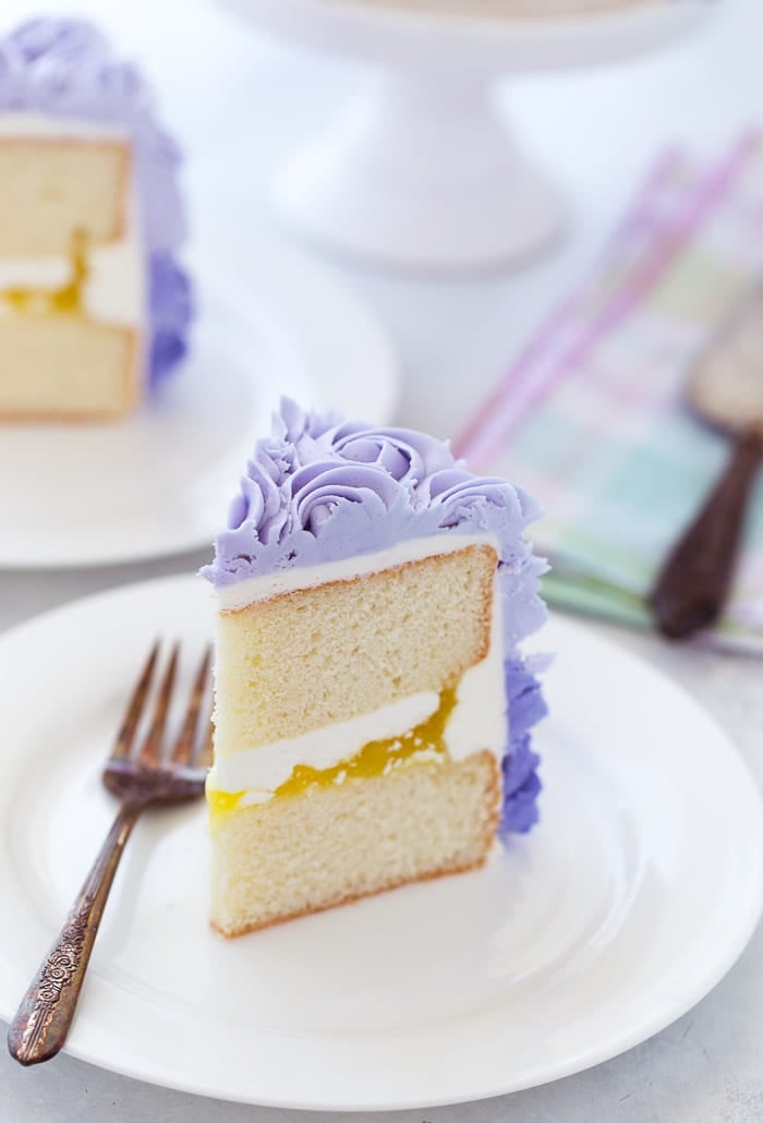A classic lemon layer cake recipe with a moist, tender lemon cake filled with lemon zest and fresh lemon juices. The cake is dressed in a beautiful ombre lemon buttercream perfect for Spring entertaining. 