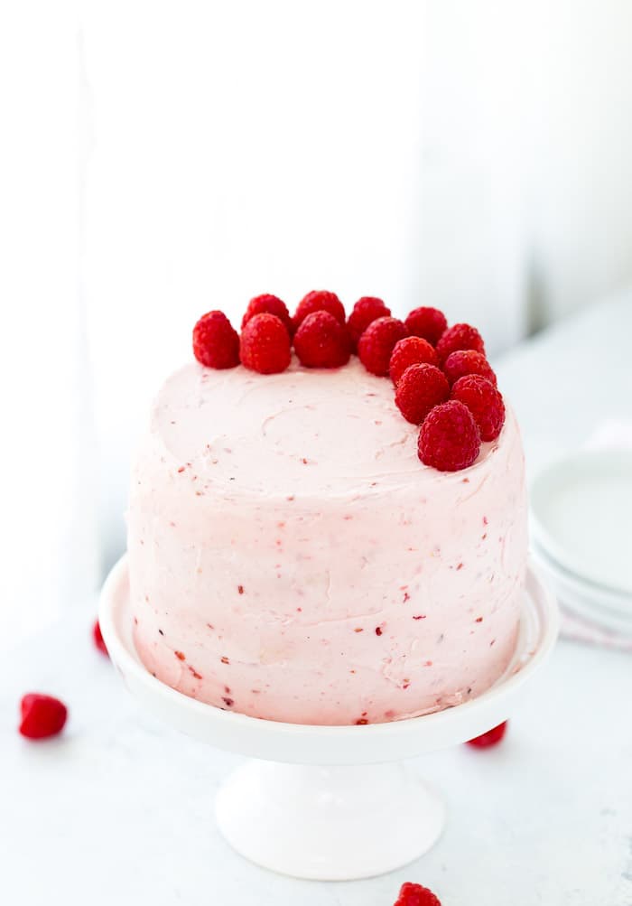 A classic Vanilla Bean Raspberry Layer Cake with moist vanilla bean cake with a sweet raspberry filling and a fluffy whipped vanilla bean frosting!