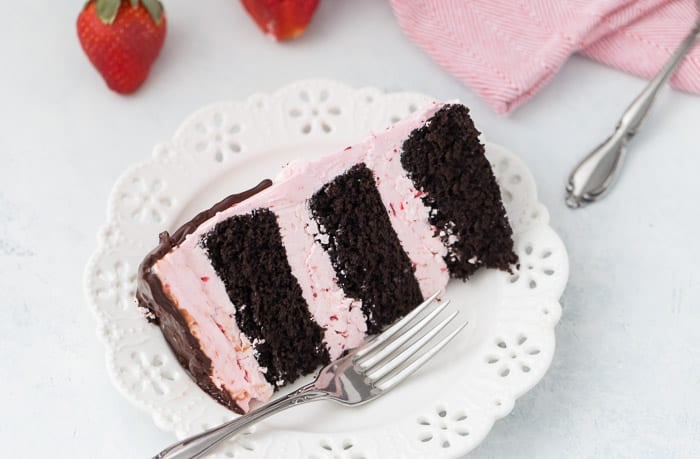 This dark chocolate strawberry cake is a great summer celebration cake for the chocolate and strawberry lovers alike. A decadent dark chocolate cake is filled with a light and fluffy fresh strawberry buttercream.