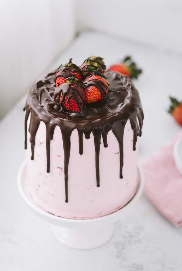 This dark chocolate strawberry cake is a great summer celebration cake for the chocolate and strawberry lovers alike. A decadent dark chocolate cake is filled with a light and fluffy fresh strawberry buttercream.