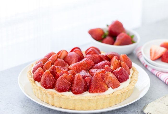 This strawberry mascarpone tart is a beautiful 3-layered tart with a buttery crust and a creamy lemon mascarpone filling topped with fresh strawberries.