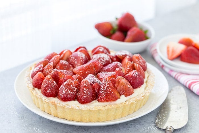 This strawberry mascarpone tart is a beautiful 3-layered tart with a buttery crust and a creamy lemon mascarpone filling topped with fresh strawberries.