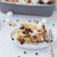 These classic s'mores cookie bars are ooey-gooey perfection with a graham cracker cookie dough crust filled with marshmallow fluff and chocolate squares.