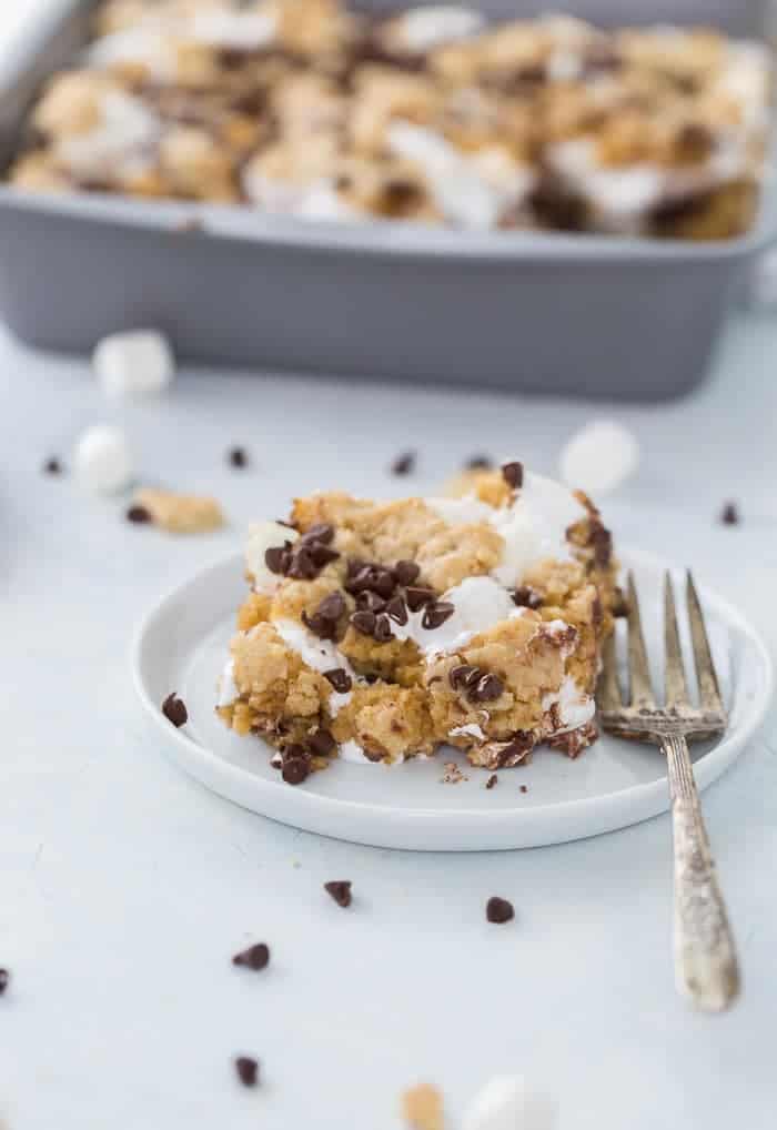 These classic s'mores cookie bars are ooey-gooey perfection with a graham cracker cookie dough crust filled with marshmallow fluff and chocolate squares.