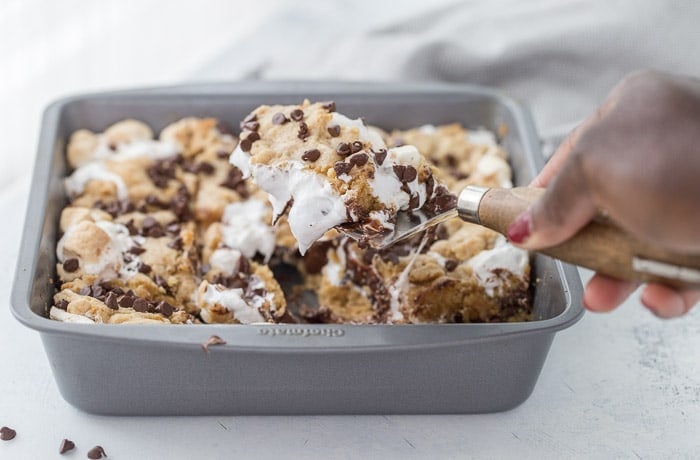These classic s'mores cookie bars are ooey-gooey perfection with a graham cracker cookie dough crust filled with marshmallow fluff and chocolate squares.