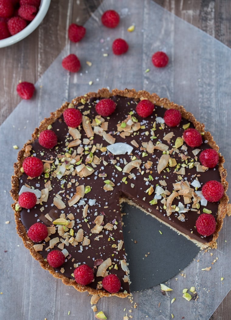 A decadent gluten free and vegan chocolate coconut tart that starts with a chewy coconut almond crust and is filled with creamy chocolate coconut ganache.