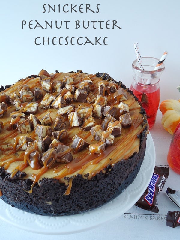 A creamy snickers peanut butter cheesecake recipe with a chocolate oreo crust and brown sugar salted caramel drizzle. Perfect for Halloween!