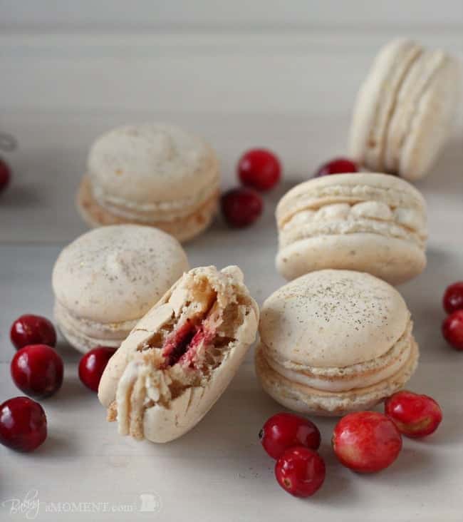 These orange walnut macarons are fun and seasonal and are filled with a subtly Spiced Cinnamon Cream Cheese Frosting and Fresh Cranberry Compote.