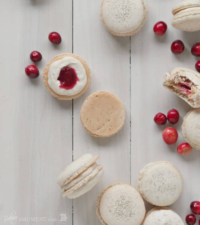 These orange walnut macarons are fun and seasonal and are filled with a subtly Spiced Cinnamon Cream Cheese Frosting and Fresh Cranberry Compote.
