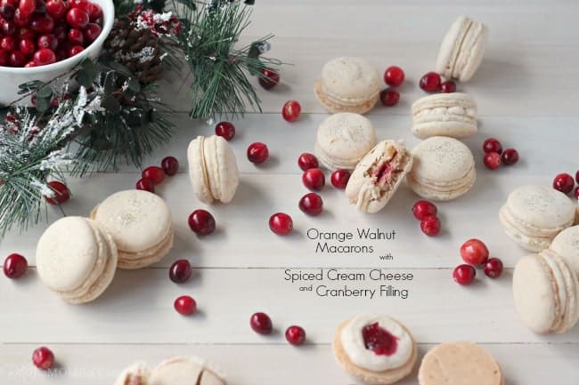 These orange walnut macarons are fun and seasonal and are filled with a subtly Spiced Cinnamon Cream Cheese Frosting and Fresh Cranberry Compote.