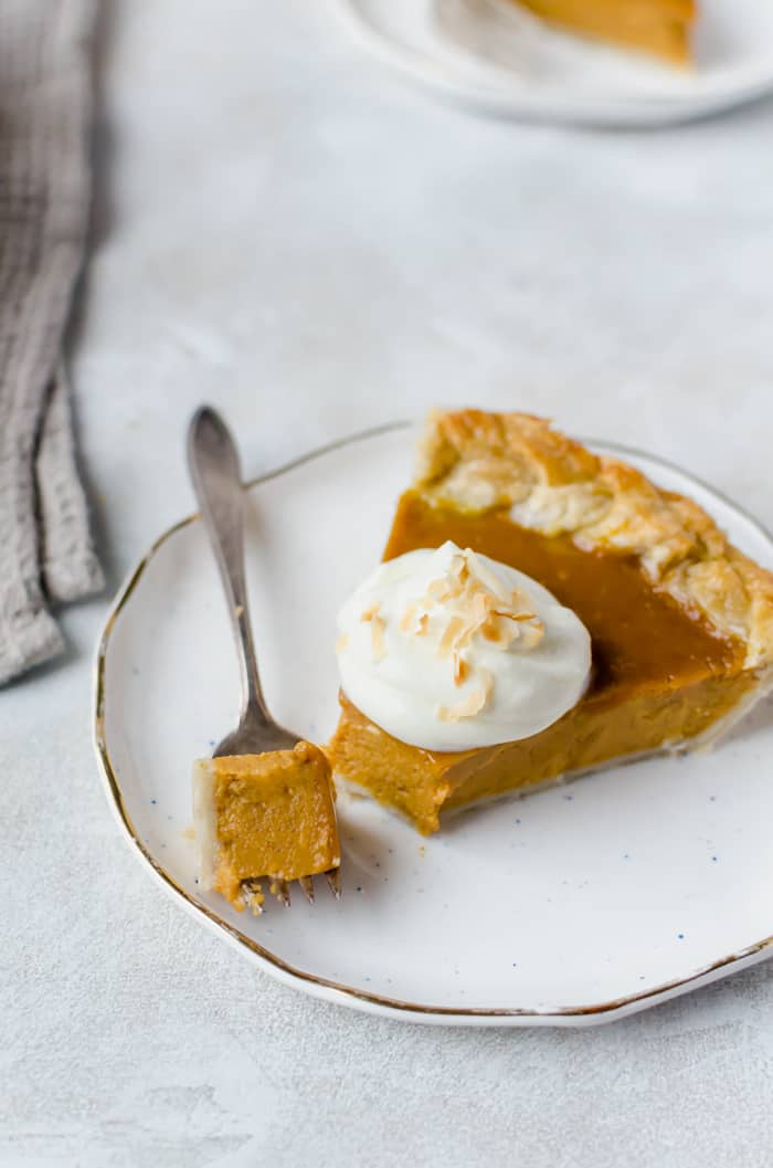 Creamy and delicious pumpkin coconut pie is topped with toasted coconut flakes. You will want this on your Thanksgiving table!