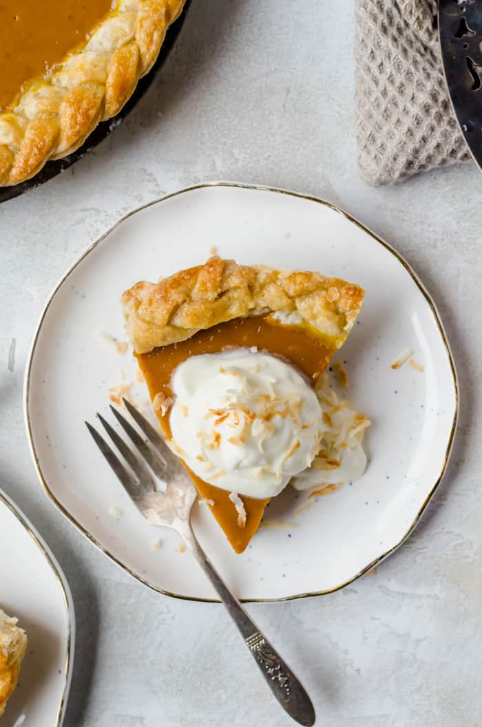 Creamy and delicious pumpkin coconut pie is topped with toasted coconut flakes. You will want this on your Thanksgiving table!