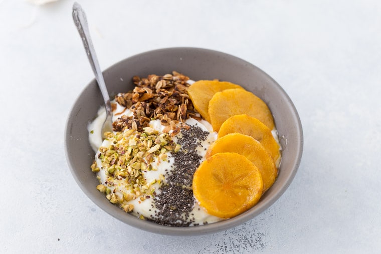 This roasted persimmon yogurt bowl is a quick and easy breakfast bowl full of winter flavors. 