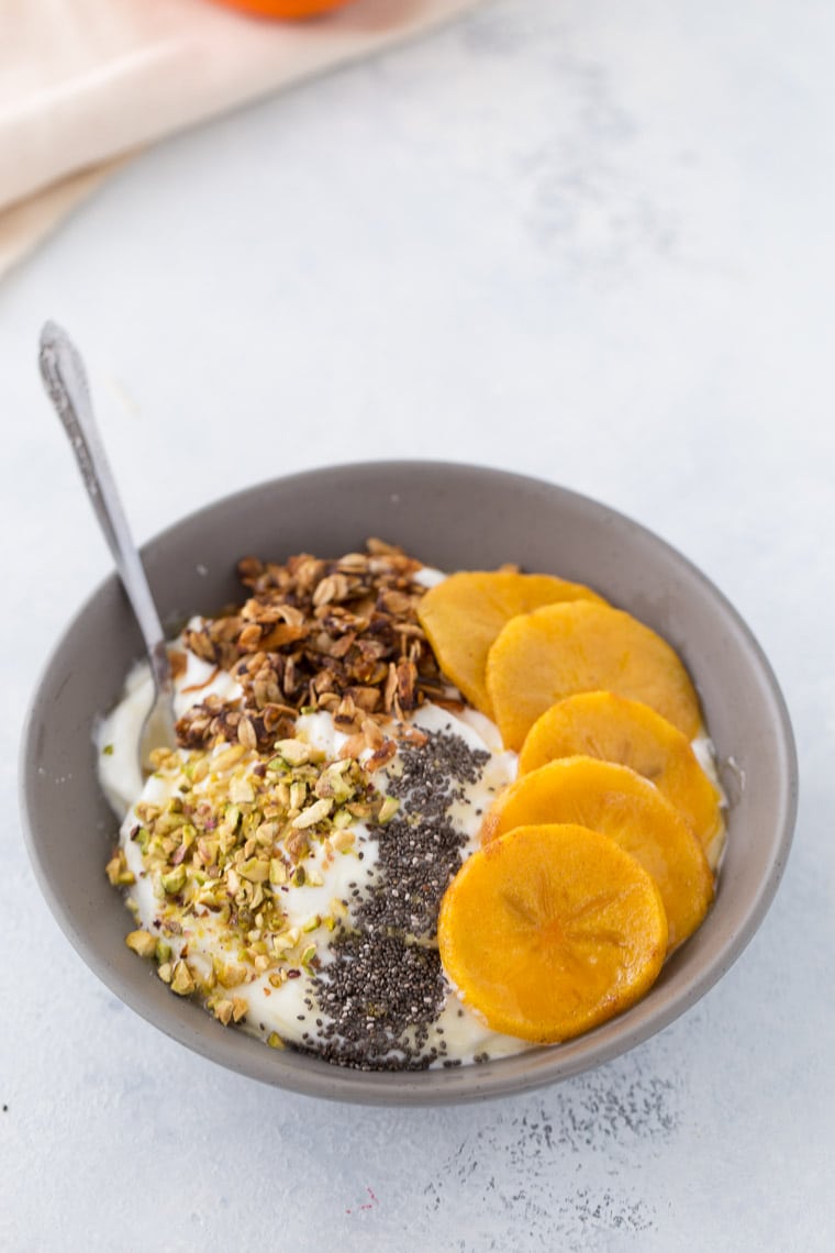 This roasted persimmon yogurt bowl is a quick and easy breakfast bowl full of winter flavors. 