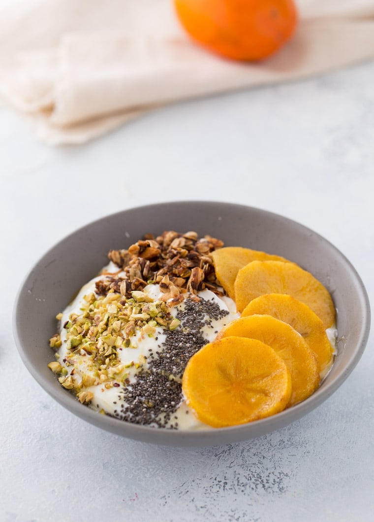 This roasted persimmon yogurt bowl is a quick and easy breakfast bowl full of winter flavors. 