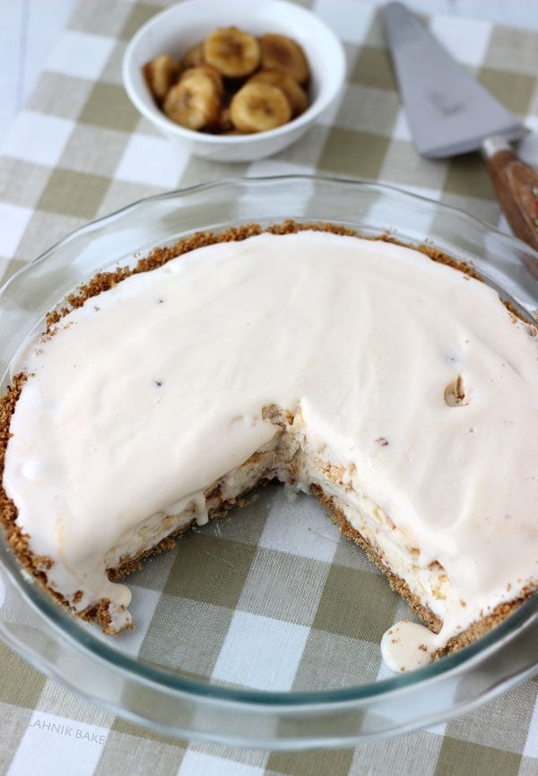 Pecan praline ice cream on top of a graham cracker crust is topped off with brown butter and brown sugar caramelized bananas in this classic banana foster pie.