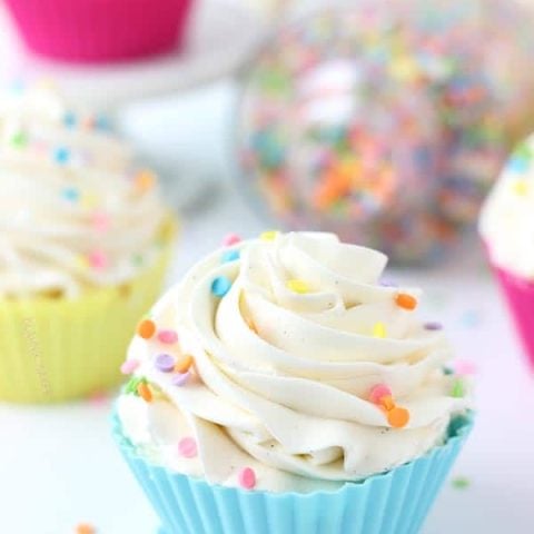 Royalty-Free photo: Cupcake served on saucer and two milk whip