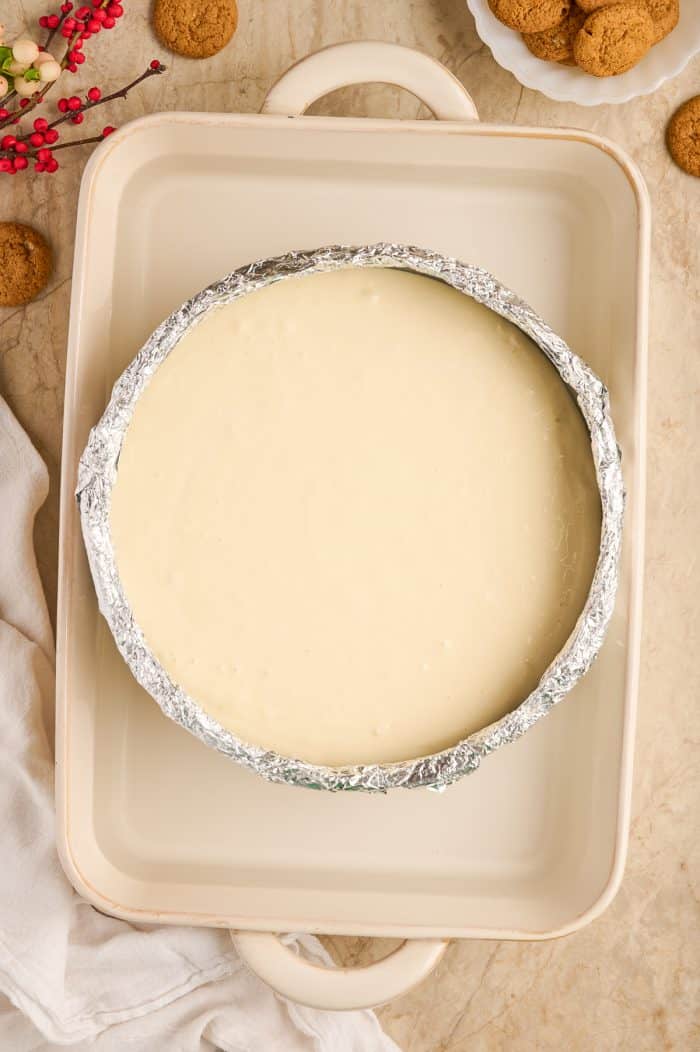 Cheesecake filling in a cheesecake pan.