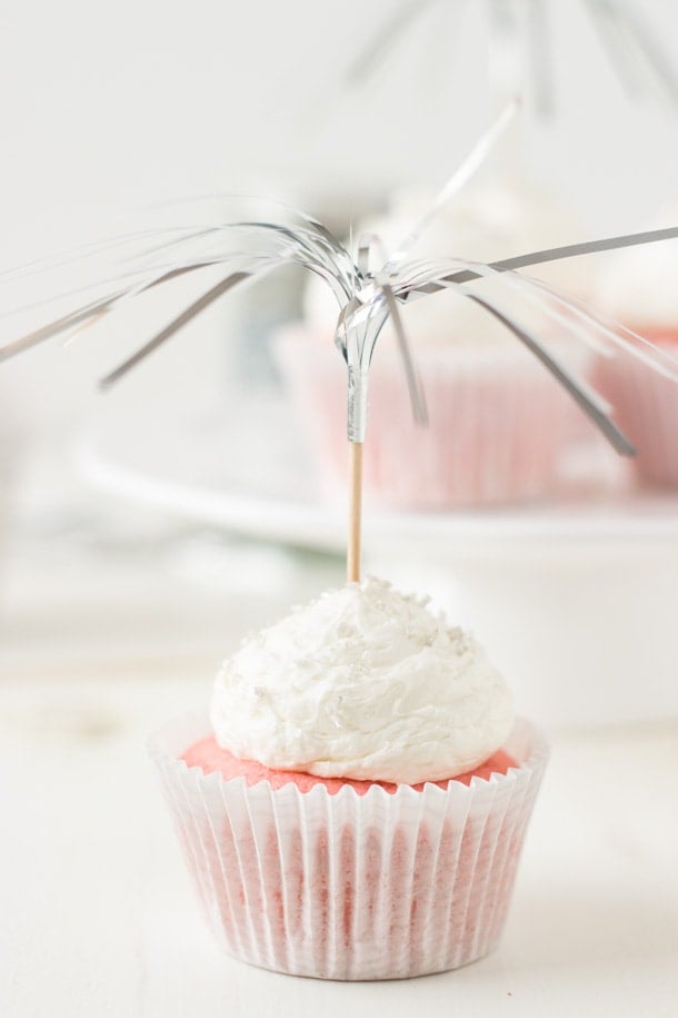 Pretty pink champagne cupcakes filled with a creamy pastry creme and topped with a sweet champagne frosting. 