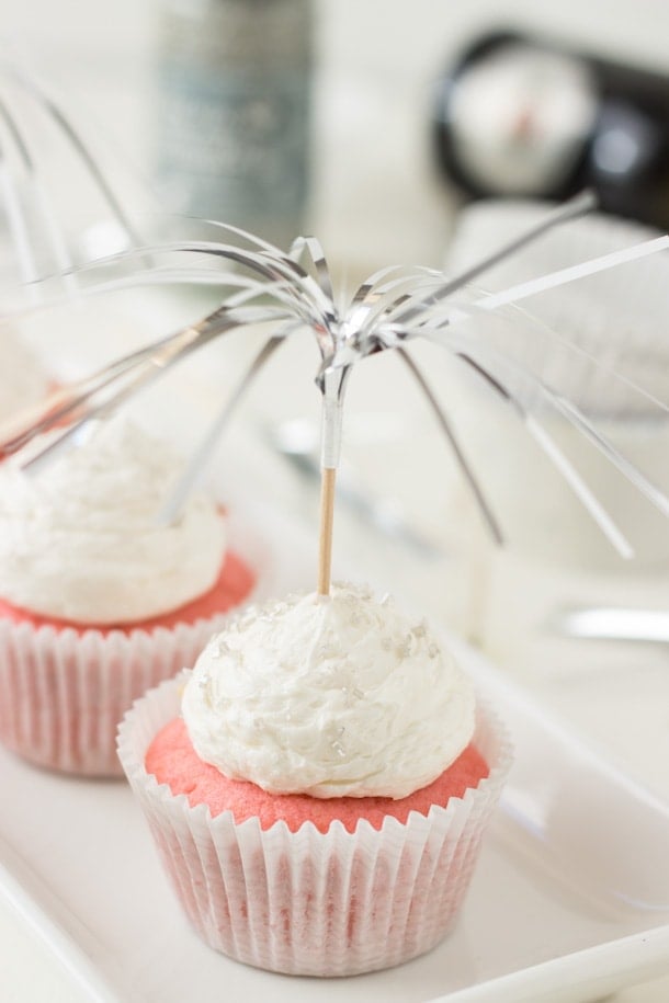 Pretty pink champagne cupcakes filled with a creamy pastry creme and topped with a sweet champagne frosting. 