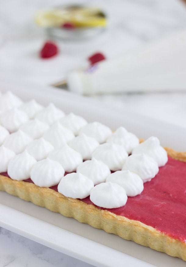 Raspberry Lemon Meringue Tart - A buttery pastry crust filled with sweet and tart raspberry lemon curd and topped with a fluffy toasted meringue.