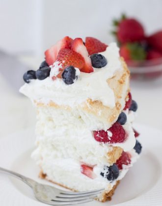 This classic angel food cake recipe is filled with homemade dairy-free coconut whipped cream and studded with berries for a pretty 4th of July look!