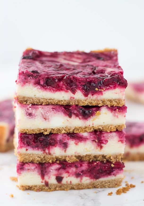 A sweet cheesecake filling is topped with a tart cherry swirl in these cherry lime cheesecake bars| via Blahnik Baker