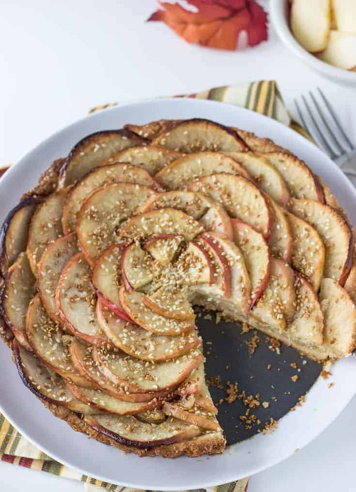 A sweet tart dough, nutty frangipane filling and toasted sesame seeds makes this apple tart recipe a winner.
