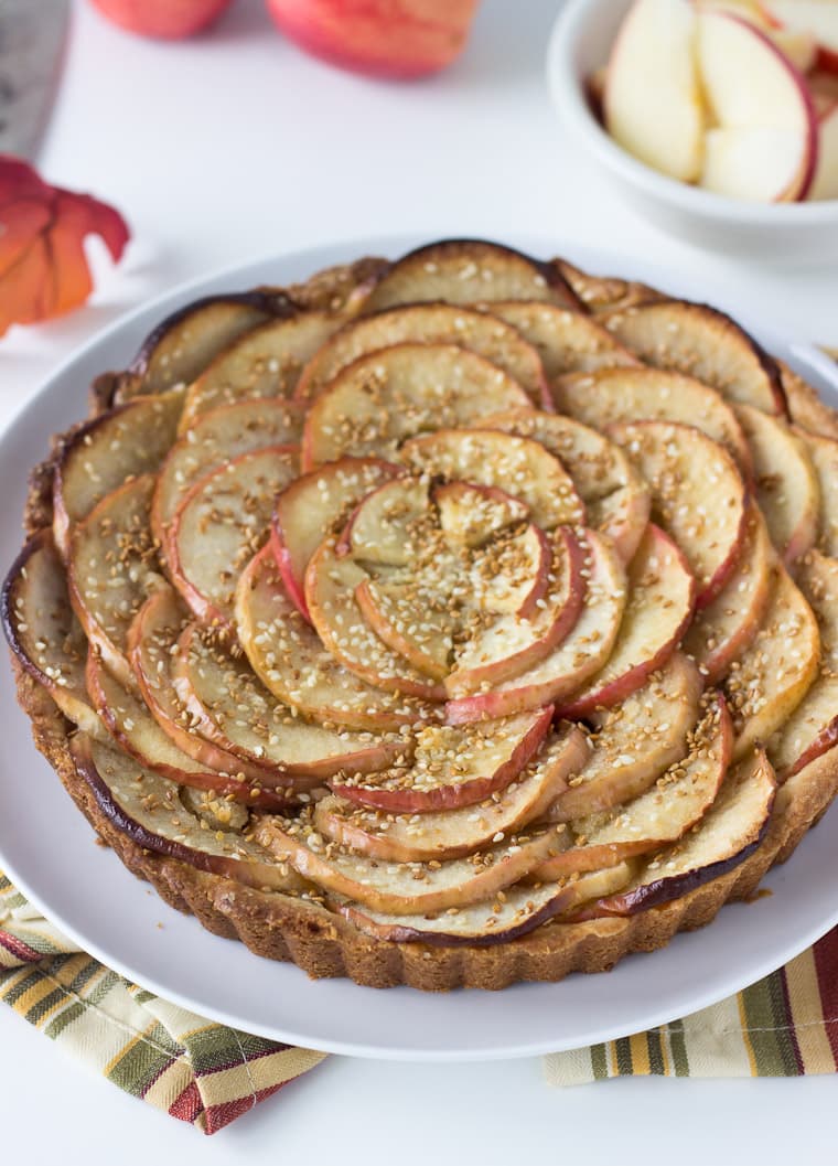 A sweet tart dough, nutty frangipane filling and toasted sesame seeds makes this apple tart recipe a winner.