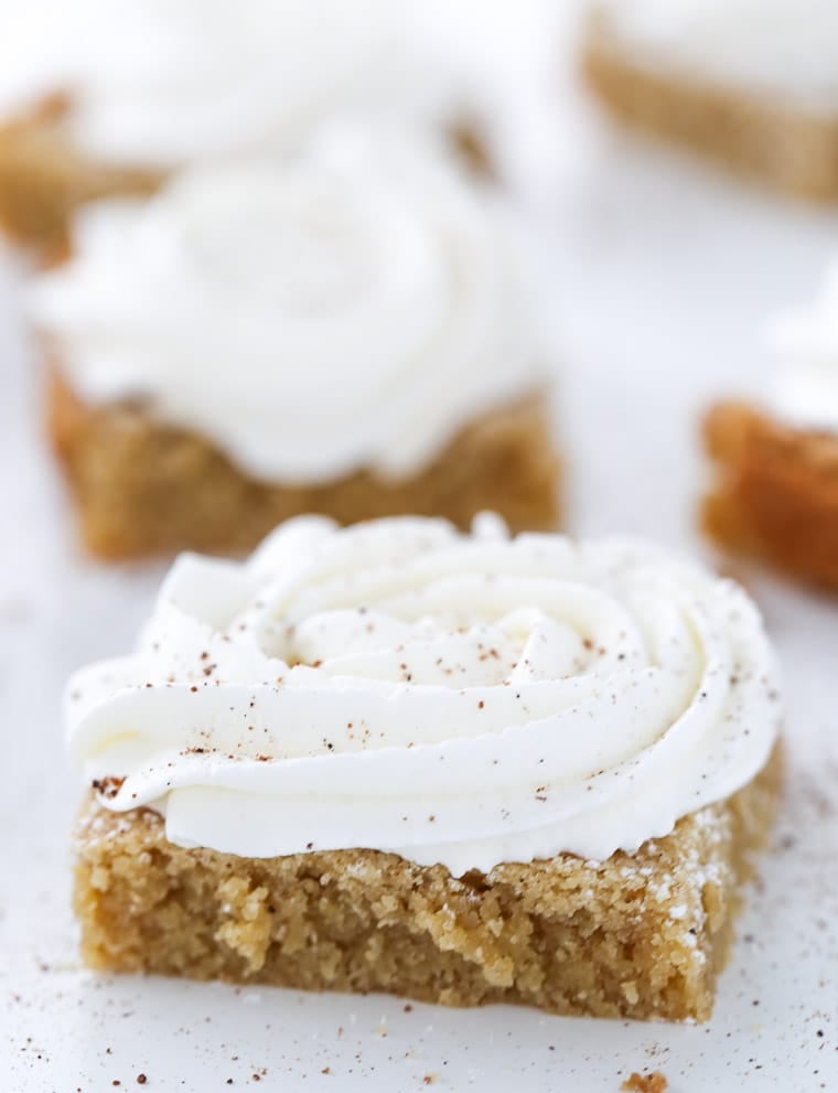 Ooey gooey eggnog cookie bars with brown butter in the batter and a sweet rum buttercream