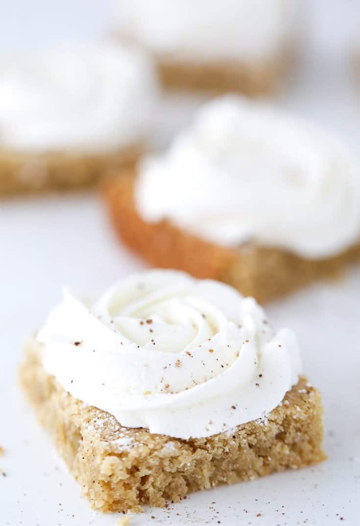 Ooey gooey eggnog cookie bars with brown butter in the batter and a sweet rum buttercream