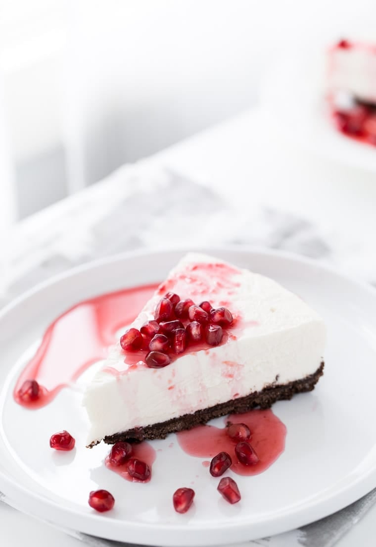 A sweet and slightly tangy Greek Yogurt Cheesecake that's topped with a sweet, vibrant pomegranate syrup. A cheesecake recipe to keep for special occasions.