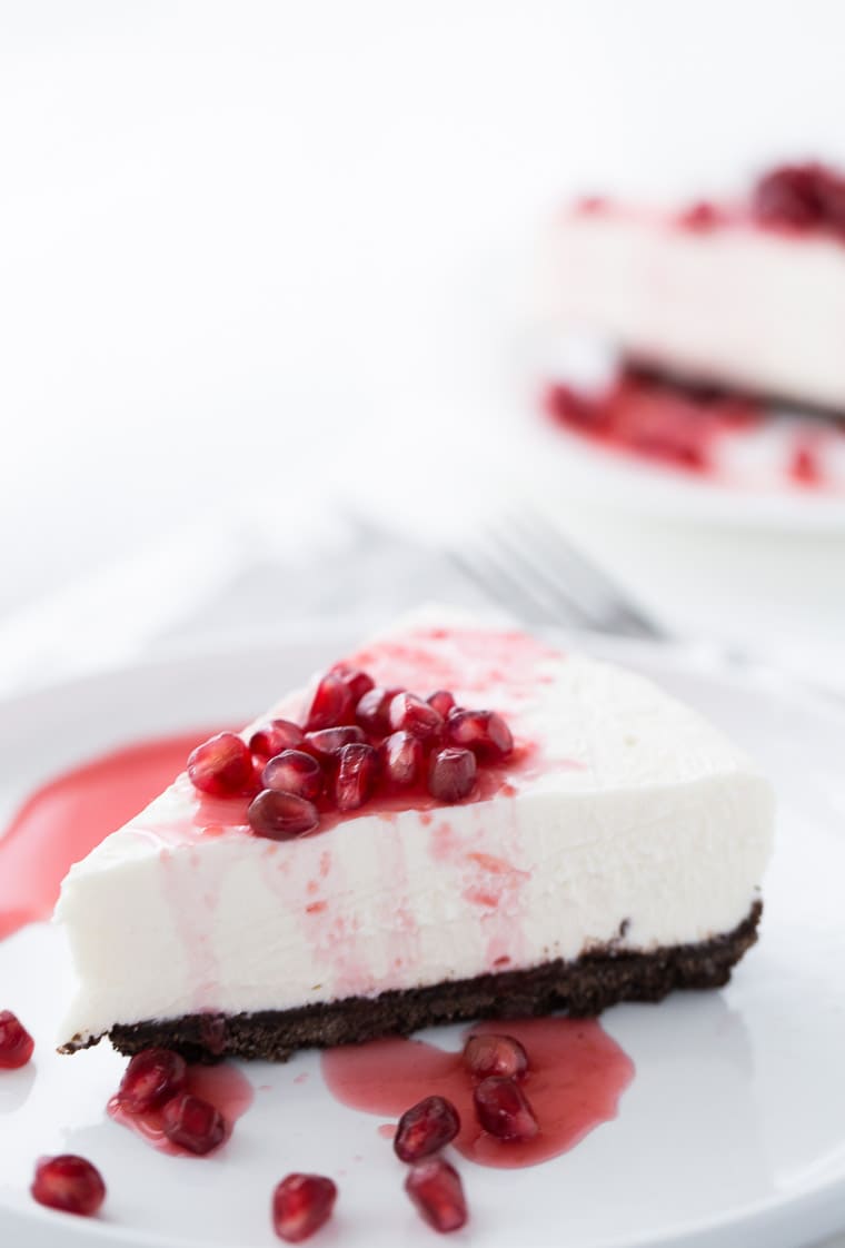 A sweet and slightly tangy Greek Yogurt Cheesecake that's topped with a sweet, vibrant pomegranate syrup. A cheesecake recipe to keep for special occasions.