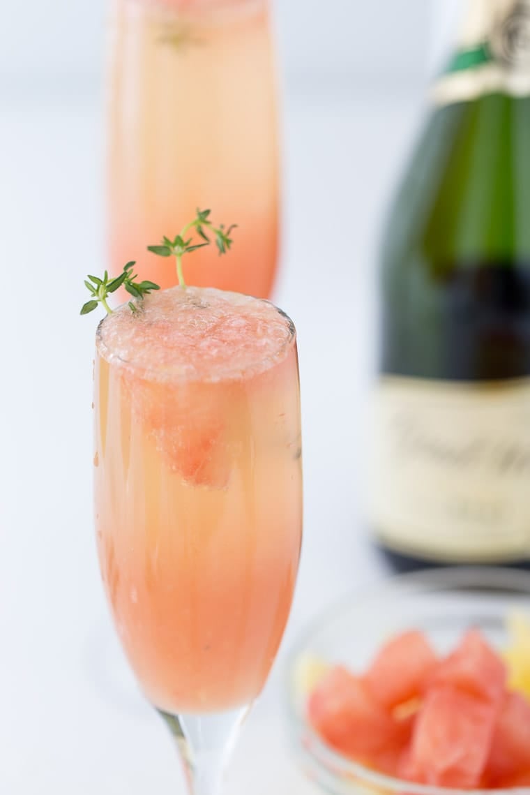 A refreshing winter mimosa, this Grapefruit Mimosa recipe is perfect for any weekend brunch with freshly squeezed grapefruit juice and fresh herbs. 