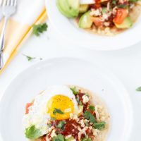 An authentic huevos rancheros recipe with homemade red chile paste, fried eggs and refried beans.