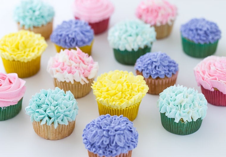 A tutorial on how to make flower cupcakes using vanilla buttercream and piping bags. These cupcakes are perfect for Spring and Mother's Day!