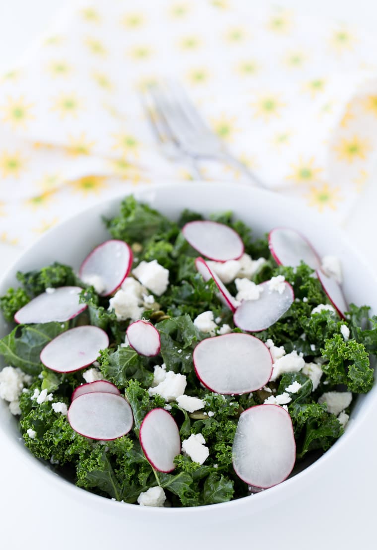 A simple and delicious homemade kale salad with radishes, pepitas, cojita cheese and lime vinaigrette. Light and fresh for a side dish or meal.