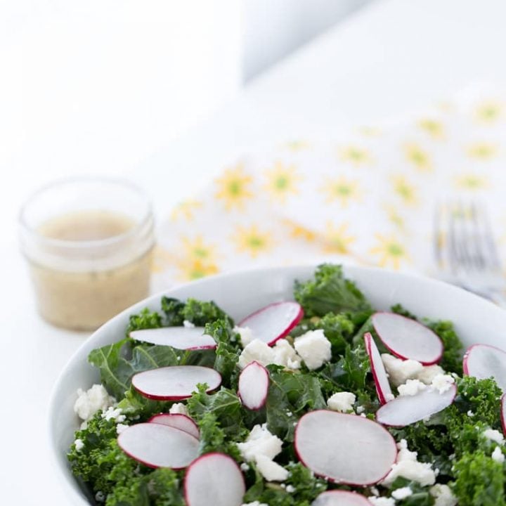 A simple and delicious homemade kale salad with radishes, pepitas, cojita cheese and lime vinaigrette. Light and fresh for a side dish or meal.