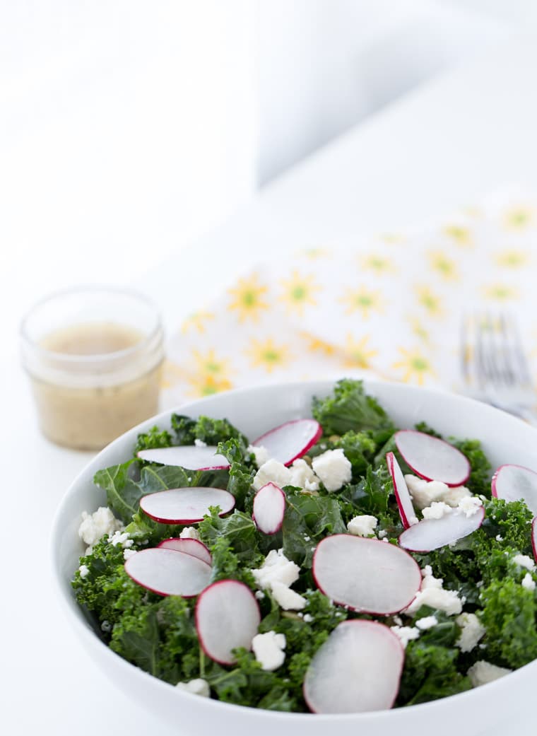 A simple and delicious homemade kale salad with radishes, pepitas, cojita cheese and lime vinaigrette. Light and fresh for a side dish or meal.