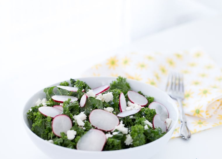 A simple and delicious homemade kale salad with radishes, pepitas, cojita cheese and lime vinaigrette. Light and fresh for a side dish or meal.