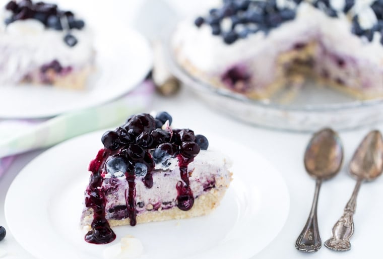 This Blueberry Coconut Ice Cream Pie is a no-bake recipe with a crunchy almond gluten free crust and is filled with coconut ice cream and blueberry sauce. 