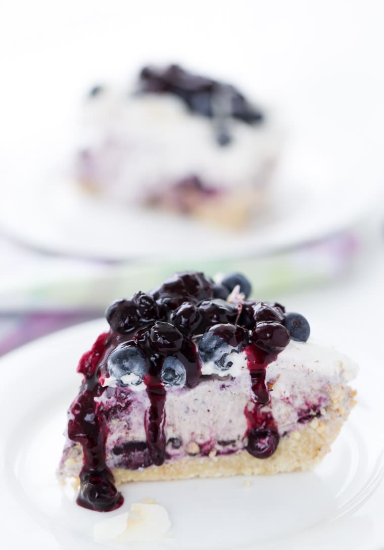 This Blueberry Coconut Ice Cream Pie is a no-bake recipe with a crunchy almond gluten free crust and is filled with coconut ice cream and blueberry sauce. 