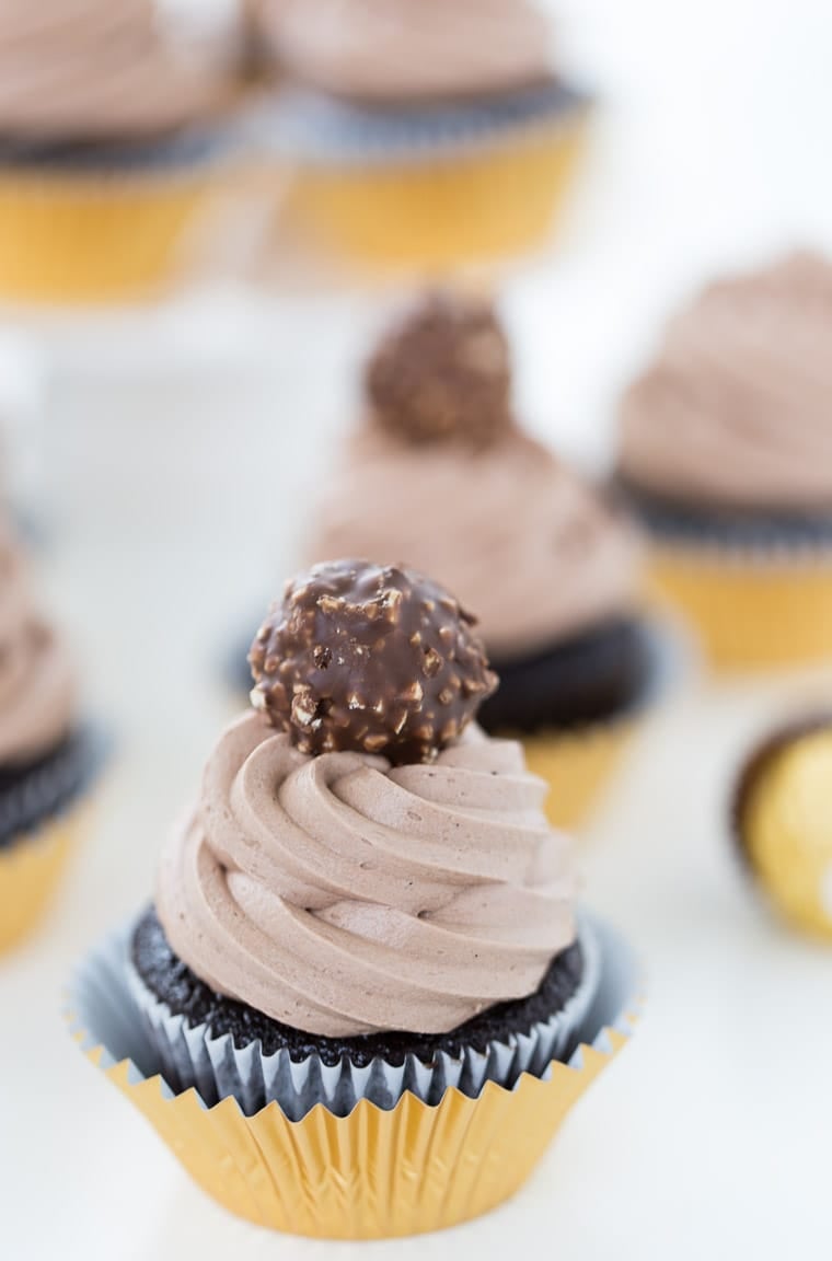 These Ferrero Rocher Cupcakes are decadent with a creamy whipped nutella frosting and a hidden ferrero rocher surprise in the cupcake. 