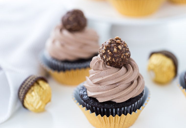 These Ferrero Rocher Cupcakes are decadent with a creamy whipped nutella frosting and a hidden ferrero rocher surprise in the cupcake. 