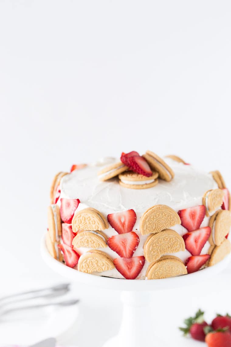 A fun and beautiful strawberry cookie cake decorated with fresh strawberries and birthday cake oreo cookies. Perfect for any birthday! 