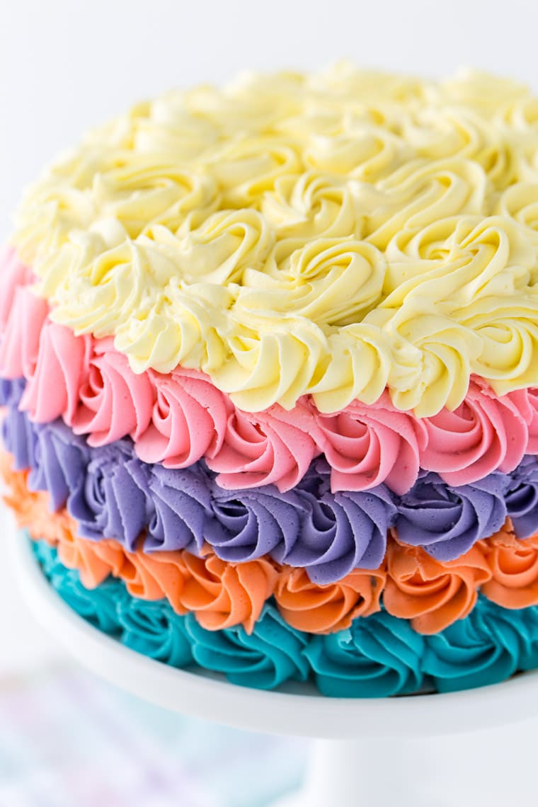 This strawberry rainbow cake is a pretty birthday cake for any girl! With a homemade strawberry cake and whipped vanilla buttercream in colorful swirls.