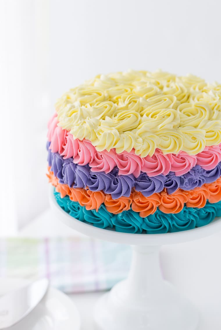 This strawberry rainbow cake is a pretty birthday cake for any girl! With a homemade strawberry cake and whipped vanilla buttercream in colorful swirls.