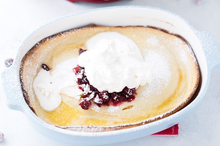 This eggnog dutch baby is a great holiday brunch pancake with perfectly spiced pancake batter and cranberry compote topping.