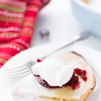 This eggnog dutch baby is a great holiday brunch pancake with perfectly spiced pancake batter and cranberry compote topping.