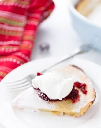 This eggnog dutch baby is a great holiday brunch pancake with perfectly spiced pancake batter and cranberry compote topping.